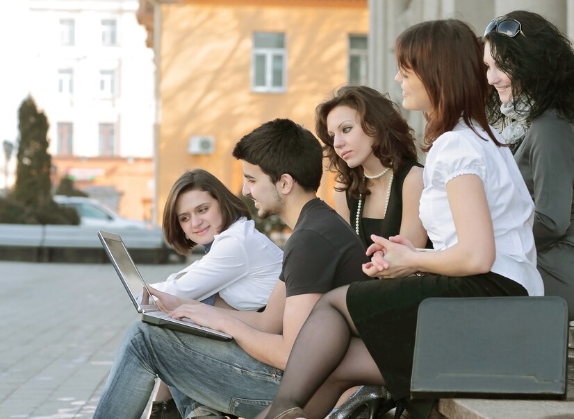 closeup-group-students-communicating-via-internet-using-laptop_160672-343