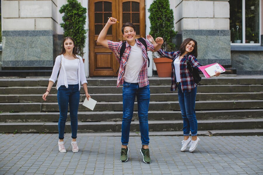 happy-students-posing-street_23-2147656153