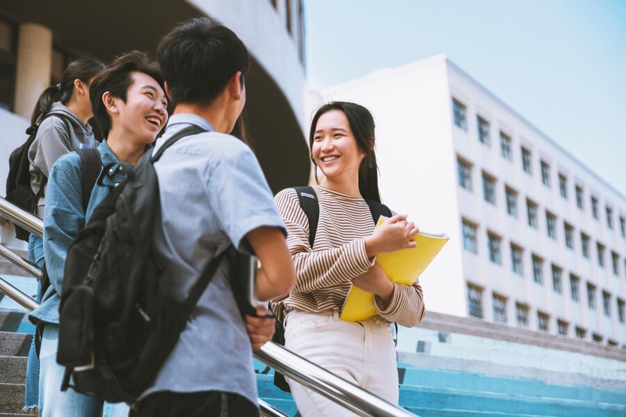 happy-teenager-students-talking-walking-stairs_928131-2379