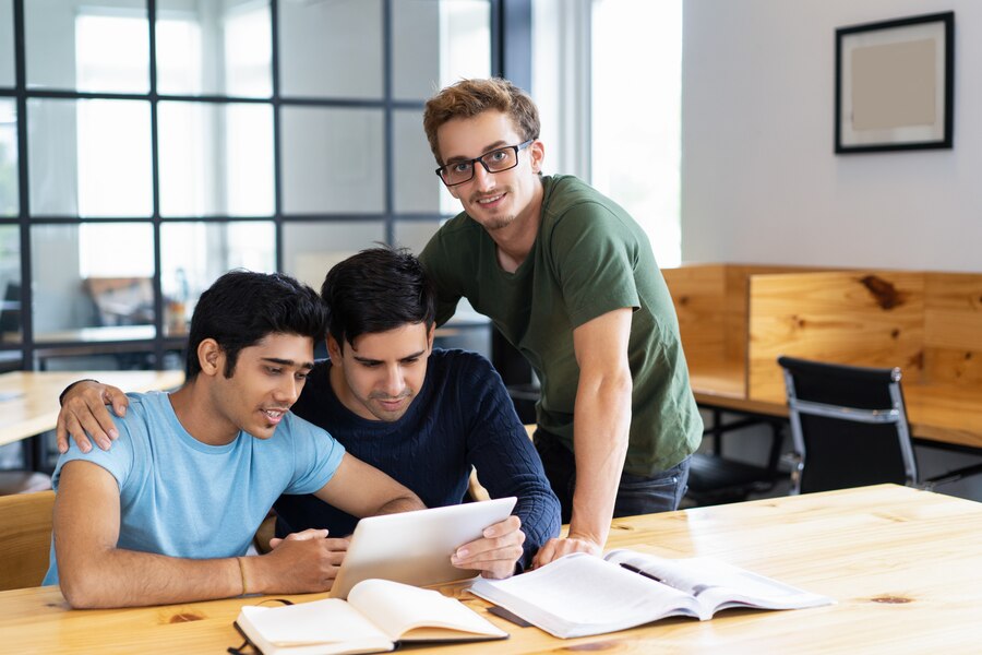 three-positive-students-browsing-tablet-computer-together_1262-15303